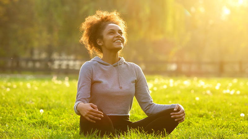 Young woman sitting in a field